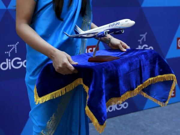 A woman holds a Indigo memento during the company's listing ceremony at the National Stock Exchange (NSE) in Mumbai, India, November 10, 2015. Interglobe Aviation, which owns Indigo Airlines, posted 24 percent increase in net profit for the quarter ended September 2016 and 18 percent rise in income from operations, year-on-year. indigo integlobe aviation q2 civil aviation share price net profit revenue sales tickets discounts offer nse bse fuel atf costs passengers domestic air traffic rivals spicejet standalone listing ipo