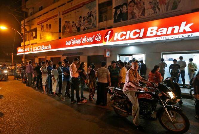 In picture: People wait to deposit and withdraw their money outside an ICICI Bank ATM in Rajkot, India, November 8, 2016. ATM