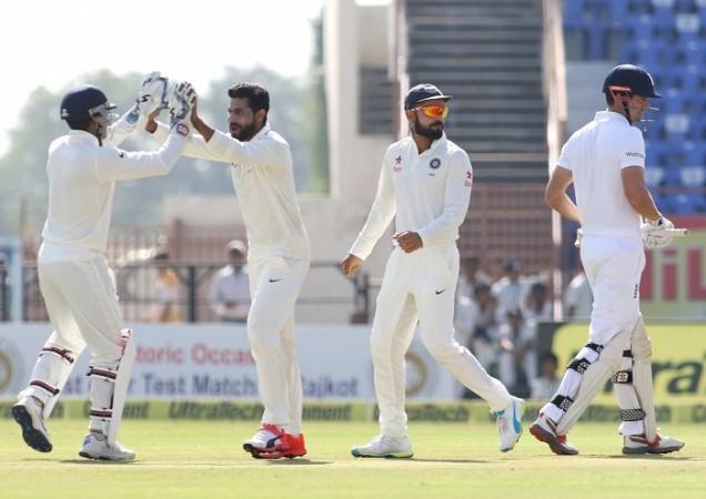 Alastair Cook walks off the field after being given out lbw as Ravindra Jadeja celebrates with his teammates, November 9, 2016 Ravindra Jadeja Virat Kohli India Alastair Cook England