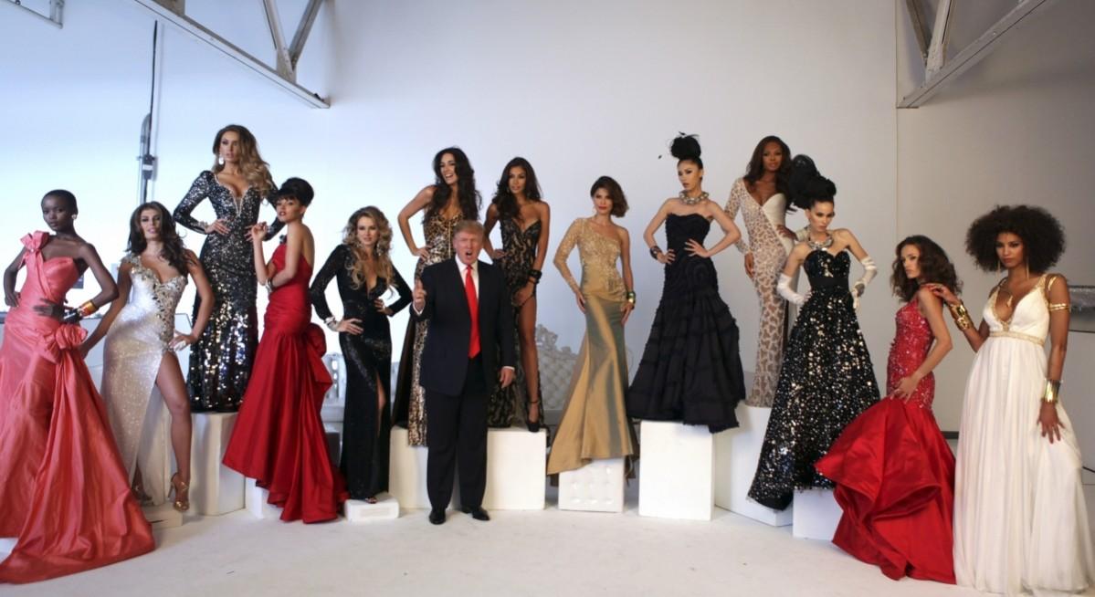 Donald Trump (C) poses with Miss Universe Beauty Queens (L-R) Flaviana Matata, Angela Martini, Rosanna Purcell, Susie Castillo, Shandi Finnessey, Amelia Vega, Dayanna Mendoza, Justine Pasek, Riyo Mori, Crystle Stewart, Zana Krasniqi, Marigona Dragusha, and Chloe Martaud during the pageant photoshoot in New York, July 27, 2011. Donald Trump