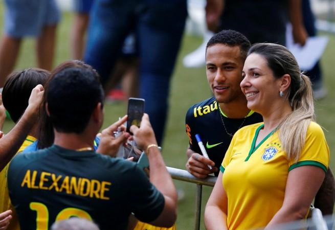 Brazil's player Neymar poses for picture with soccer fans after a training session at the Mineirao Stadium, Belo Horizonte neymar brazil