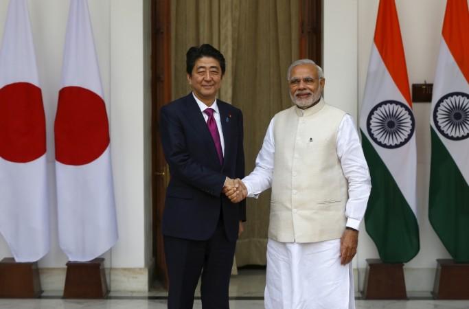 Japan's Prime Minister Shinzo Abe (L) shakes hands with his Indian counterpart Narendra Modi during a photo opportunity ahead of their meeting at Hyderabad House in New Delhi December 12, 2015. Narendra Modi in Japan