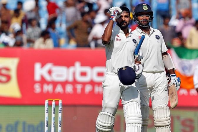 India opener Murali Vijay celebrates after completing his hundred as fellow centurion Cheteshwar Pujara looks on, November 11, 2016 Murali Vijay Cheteshwar Pujara India