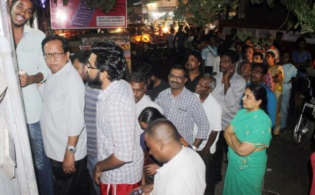 People wait to withdraw money from ATM even at night People wait to withdraw money from ATM even at night