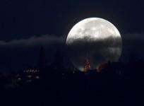 The supermoon is partly covered by clouds
