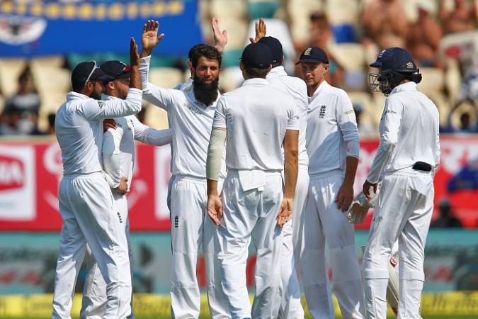 England spinner Moeen Ali celebrates with his teammates after picking up the wicket of India captain Virat Kohli, November 18, 2016 Moeen Ali England
