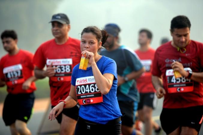 Participants run at the Airtel Delhi Half Marathon 2015 at India Gate in New Delhi delhi half marathon
