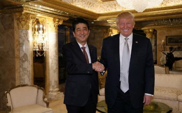 Donald Trump shakes hands with Japanese Prime Minister Shinzo Abe in Trump Tower, New York. Sinzo Abe- Donald Trump