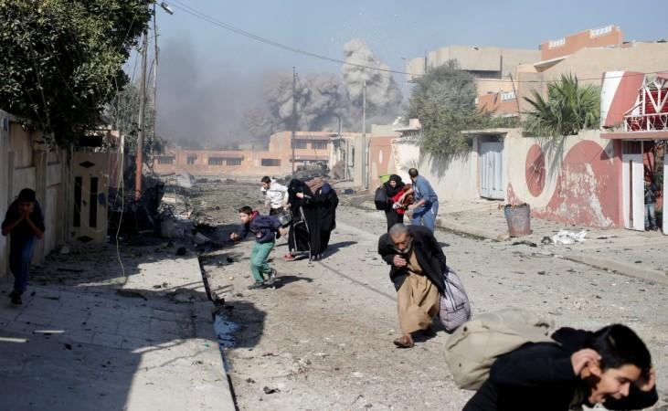 People run in panic after a coalition airstrike hit Islamic State fighters positions in Tahrir neighbourhood of Mosul, Iraq Battle for Mosul
