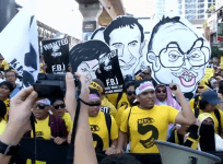 Malaysia painted red and yellow as government rivals rally in capital