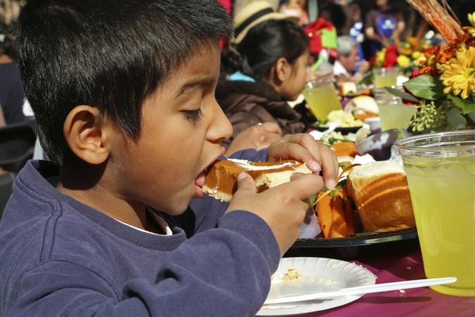 Justin Felix, 6, eats a slice of pumpkin pie at the Los Angeles Mission on skid row for an early Thanksgiving meal served to the homeless and others in Los Angeles, California November 27, 2013. Thanksgiving