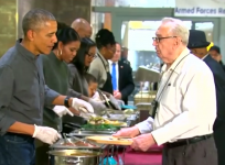 Barack Obama serves Thanksgiving lunch with a smile
