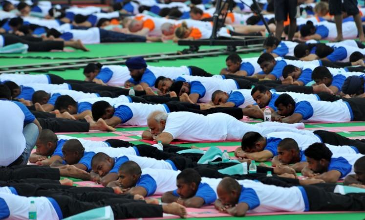 Snooze mode: Prime Minister Narendra Modi participating in the mass yoga demonstration at the Capitol Complex, Chandigarh, on the occasion of the 2nd International Day of Yoga – 2016, on June 21, 2016. The opposition is baying for Modi's blood both in and outside the Parliament ever since he demonetised high-denomination currencies in a surprise announcement on November 8, 2016. But his party members have staunchly defended the move, saying it is a demonetisation pm narendra modi yoga dgp conference hyderabad sensex rupee fall affidavit supreme court petition case crime loot robbery cash banks atm queue arun jaitley us fed interest rate hike bjp congress dgp jdu nda upa