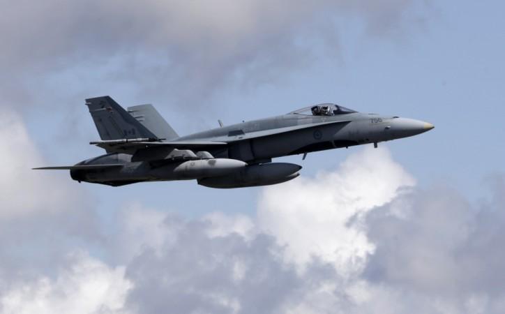 A Canadian Air Task Force jet CF-18 flies over Siauliai air base F-18 Hornet