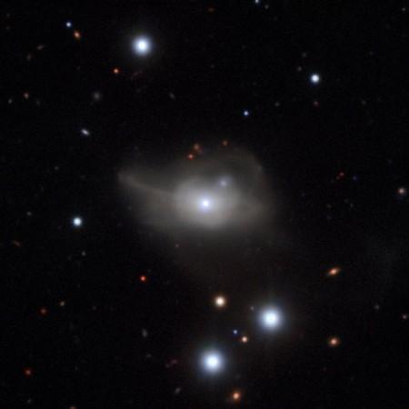 This image from the MUSE instrument on ESO's Very Large Telescope shows the active galaxy Markarian 1018, which has a supermassive black hole at its core. The faint loops of light around the galaxy are a result of its interaction and merger with another galaxy in the recent past. galaxy Markarian 1018