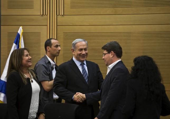 Israel's Prime Minister Benjamin Netanyahu (C) shakes hands with lawmaker Ofir Akunis (R) during a Likud party meeting at parliament in Jerusalem May 11, 2015. global technology summit speakers israel ofir akunis israel india trade relations science and technology delegation