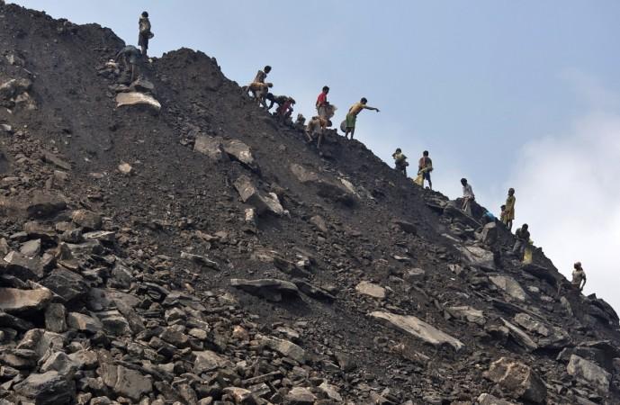 Locals collect coal from the dumpsite of an open coal field of Coal India Limited (CIL) at Dhanbad district in the eastern Indian state of Jharkhand. CIL plans to recruit about 9,000 people including 4,000 at the executive level to fill up the backlog of retired hands. (A representational image) ntpc coal jharkhand mines india cil coal india share price net profit reserves billion exploration power energy