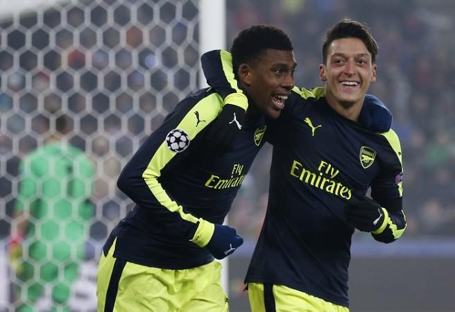 Arsenal playmakers Alex Iwobi and Mesut Ozil celebrate a goal against Basel in the Champions League, December 6, 2016 Alex Iwobi Mesut Ozil Arsenal