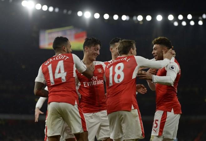 Arsenal players celebrate a goal scored by Mesut Ozil in their Premier League game against Stoke City, December 10, 2016 Arsenal