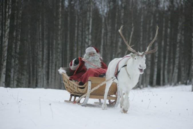 A man dressed as Santa Claus rides his sleigh as he prepares for Christmas on the Arctic Circle in Rovaniemi, northern Finland. Santa Claus