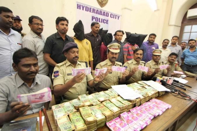 Police presents before press Rs 34 lakh new currency notes and Rs 24 lakh old currency notes in Hyderabad on Dec 8, 2016. The daily cash seizures of new currency notes running into lakhs and crores of rupees has worsened the cash supply situation at ATMs. december salary employees cash crunch demonetisation