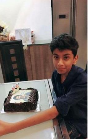 Aryan with birthday cake having Prabhas picture on it. Prabhas fan
