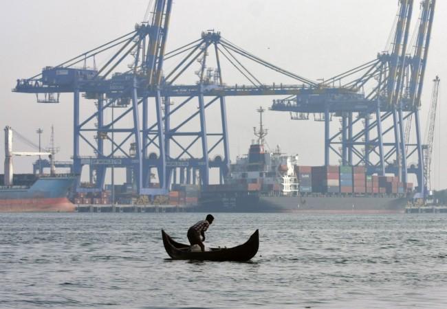 A fisherman prepares to cast his fishing net in the waters of the Vembanad lake. India shipping ports