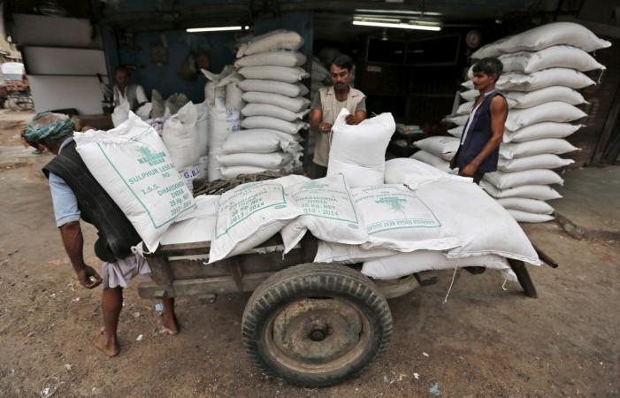 Workers unload sacks containing sugar from a handcart at a wholesale market in Ahmedabad, India, August 5, 2015 (representational image). sugar production india isma estimates crushing consumption demonetisation