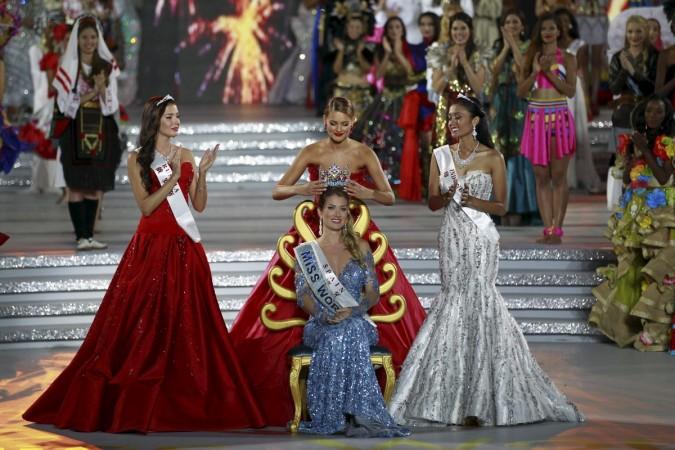 Miss Spain Mireia Lalaguna Royo (C) receives the crown from 2014 winner Rolene Strauss of South Africa (rear), as she is flanked by second-placed Miss Russia Sofia Nikitchuk (L) and third-placed Miss Indonesia Maria Harfanti, during the Miss World 2015 pageant in Sanya, Hainan province, China, December 19, 2015. Miss World 2015