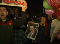 Pro-Assad Syrians celebrate in streets of Aleppo as government declares victory