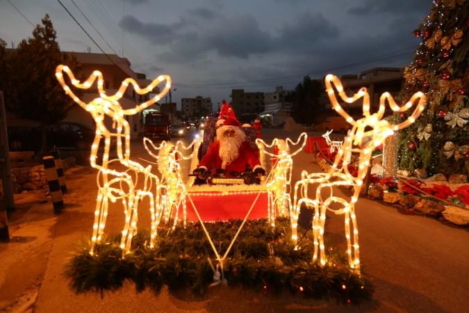 A man dressed as Santa Claus rides a Christmas decorated vehicle in Jiyeh, south Lebanon December 23, 2016. Christmas