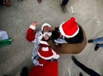 Israeli guards fire tear gas at Palestinians dressed up as Father Christmas