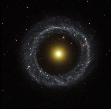 A nearly perfect ring of hot, blue stars pinwheels about the yellow nucleus of an unusual ring galaxy known as Hoag's Object. This image from NASA's Hubble Space Telescope captures a face-on view of the galaxy's ring of stars, revealing more detail than any existing photo of this object. The galaxy is 600 million light-years away in the constellation Serpens. The Wide Field and Planetary Camera 2 took this image on July 9, 2001. Hoag's Object: Nasa finds similar rare galaxy