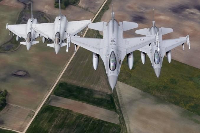 Norwegian Air Force's F-16 fighters (R) and Italian Air Force's Eurofighter Typhoon fighters patrol over the Baltic during a NATO air policing mission from Zokniai air base near Siauliai, Lithuania NATO jets in the Baltic, Russians in the Baltic, Vladimir Putin, Turkey Erdogan