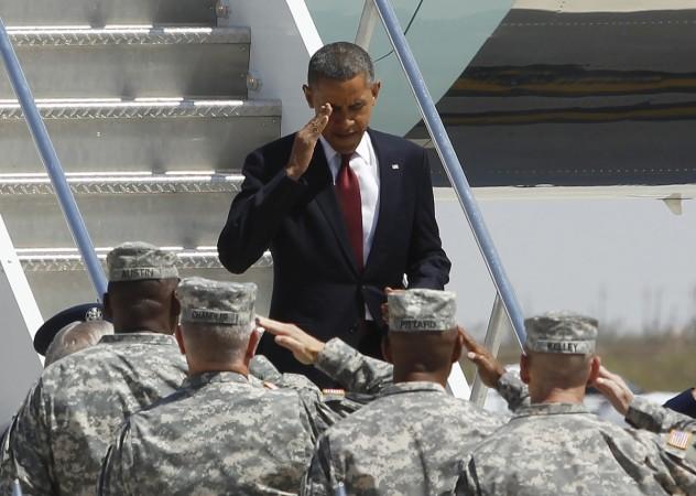 US President Barack Obama is greeted by US Army General Lloyd Austin and other high ranking officers . President Obama