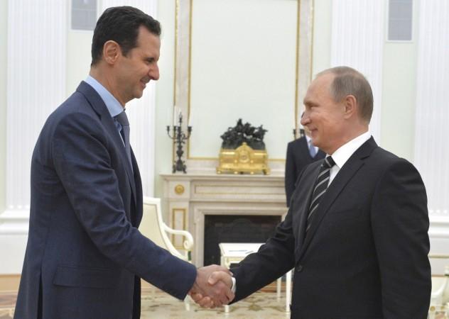 Russian President Putin shakes hands with Syrian President Assad during a meeting at the Kremlin in Moscow Putin and Assad
