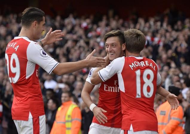 Arsenal playmaker Mesut Ozil celebrates with Granit Xhaka and Nacho Monreal after scoring the winner against Swansea City, October 15, 2016 Granit Xhaka, Mesut Ozil, Nacho Monreal, Arsenal, Premier League, Swansea City