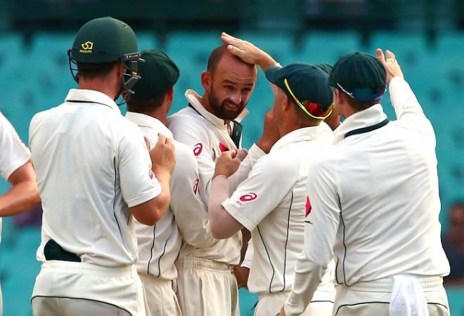 Australians celebrate after the experienced spinner Nathan Lyon (centre) dismisses a batsman. Australia cricket, Nathan Lyon, Australia squad, Australia spinners, India vs Australia
