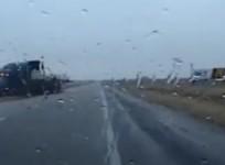 Police officer swerves to avoid overturning truck