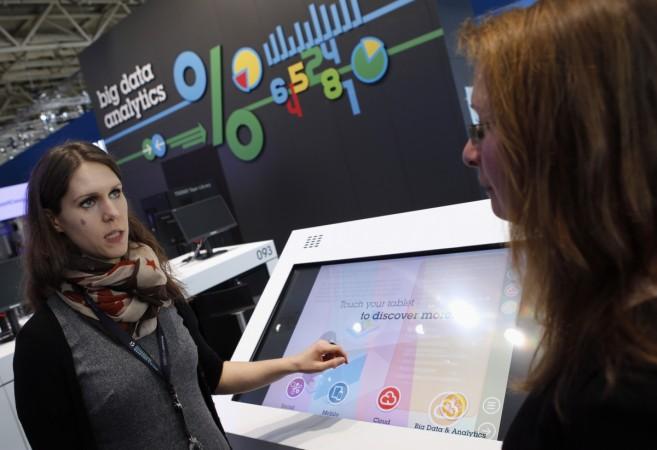 An exhibitor explains the usage of big data analytics at the booth of IBM during preparations for the CeBIT trade fair in Hanover, March 9, 2014 (representational image). big data, demonetisation, analytics, india, pm modi, cash crunch, data users, data mining, brillio, manoj kalyan
