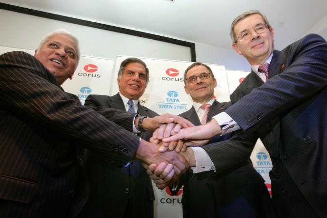 (L to R) B Mutharaman, Managing Director of Tata Steel, Ratan Tata, then Chairman of Tata Steel, James Leng, Chairman of Corus, and Philippe Varian, Chief Executive of Corus, shake hands during a photocall in central London, following the announcement that the Indian company would purchase Anglo-Dutch steel company Corus, October 20, 2006 (representational image). book review, goras and desis, omkar goswami, managing agencies, managing agency, n r narayana murthy, gurucharan das