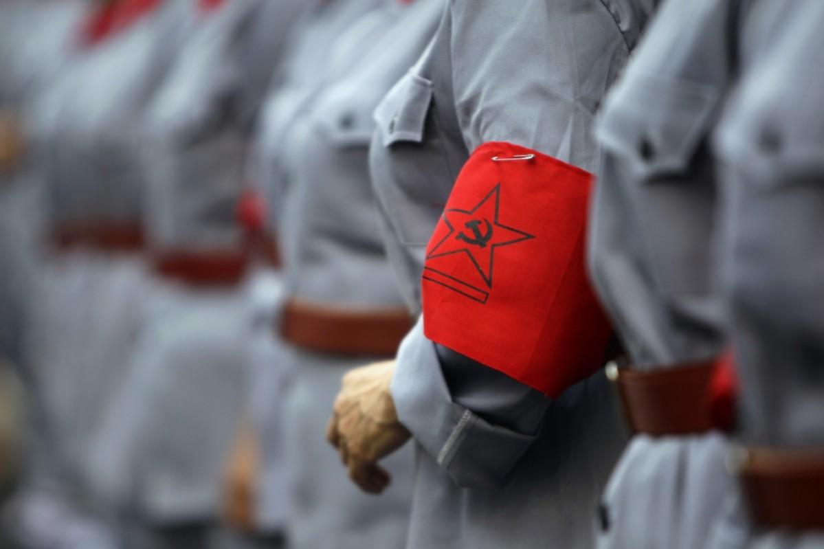 A logo of the Communist Party of China (CPC) is seen on a participant's Red Army uniform A logo of the Communist Party of China (CPC) is seen on a participant's Red Army uniform