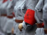 A logo of the Communist Party of China (CPC) is seen on a participant's Red Army uniform