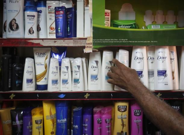 A salesman takes a bottle of Hindustan Unilever Limited (HUL) Dove shampoo from a shelf at a shop in Mumbai April 30, 2013. hul, hul q4 results, hul share price, hul products, hul competitors, patanjali ayurved, baba ramdev