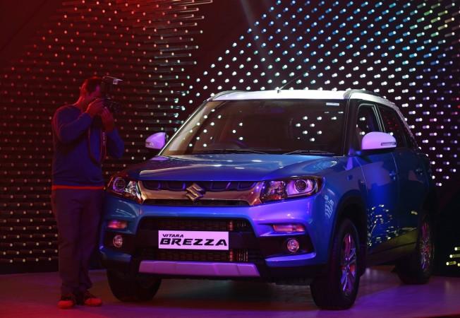 A photographer takes pictures of Maruti Suzuki Vitara Brezza car during its launch in Mumbai, India, March 8, 2016. maruti suzuki, msil share price, msil q3 results, maruti vitara brezza, maruti suzuki ignis