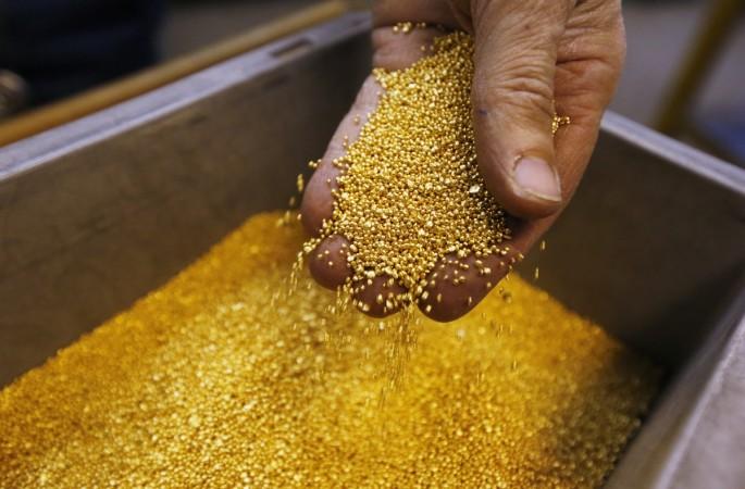A worker casts a gold bar of melted granules in the Austrian Gold and Silver Separating Plant Oegussa in Vienna June 2, 2009. weird news, gold bars, gold prices, golds jewellery, gold weapons, gold car, gold dragon, gold reserves, gold lingerie