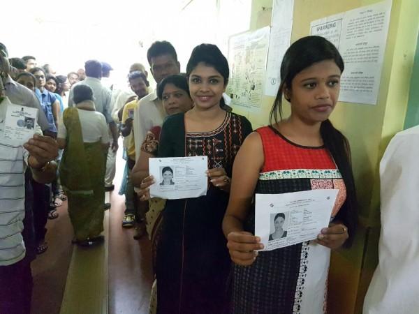 Panaji: Voters show their voter ID cards as they wait in a queue to cast their vote at a polling booth during Goa Legislative Assembly polls in Panaji, on Feb 4, 2017. Goa Assembly elections, Goa polling, Panaji voting