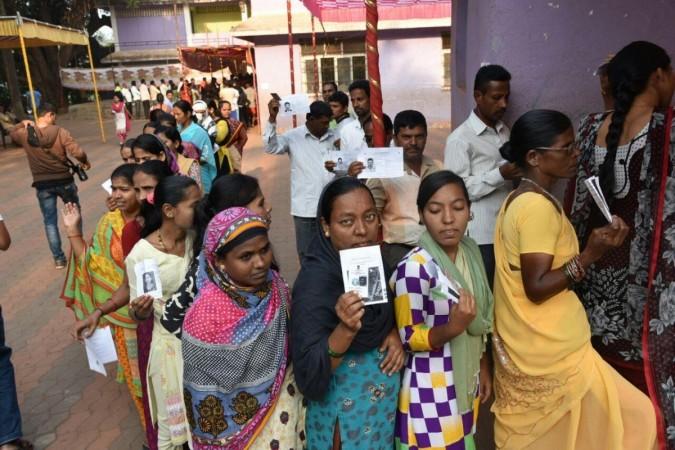 Chimbel: Voters show their voter ID cards as they wait in a queue to cast their vote at a polling booth during Goa Legislative Assembly polls in Chimbel, Goa on Feb 4, 2017. Goa Legislative Assembly polls, Goa Assembly elections, Goa voters