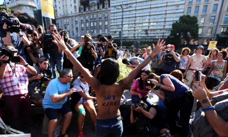 A woman poses topless with the words Argentina protests