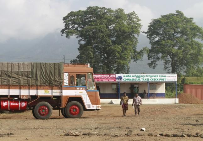 Truck drivers walk out of a Commercial Taxes Department check post after getting clearance to cross a checkpoint with their goods at the Chavadi checkpoint on the outskirt of Coimbatore in the southern Indian state of Tamil Nadu, India, September 5, 2015 (representational image). gst from 1 july, allcargo logistics q3, gati q3 results, gst logistics stocks, allcargo share price, gati share price, concor share price, gateway distriparks